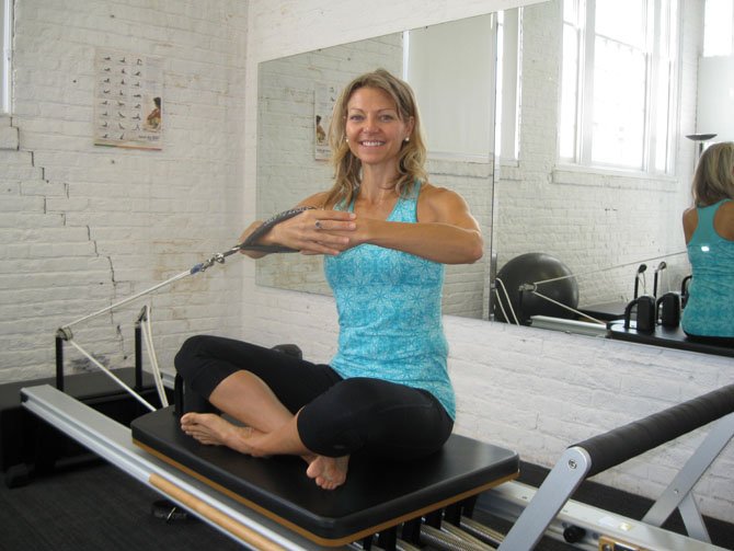 Art of Movement Program Director Lesley Spalding practices side twist pilates at the Workhouse Arts Center.
