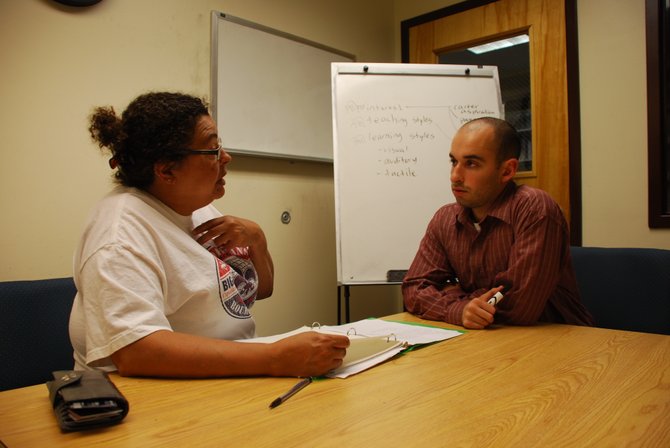 Brian Katkin, owner of Up to Speed Tutors, right, works with client Ronettee Hicks in the NOVA-Annandale campus library.