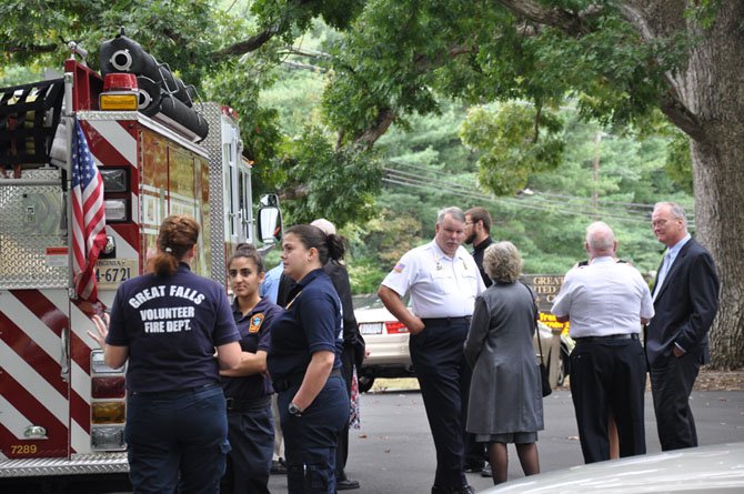 Members of the Great Falls Volunteer Fire Department, including GF Volunteer Fire Chief Franklin Smith III and former Chief Homer Johns, talk with family members at a memorial service for local volunteer firefighter and Santa representative, Dr. Christopher Earl “Doc” Kennemer.
