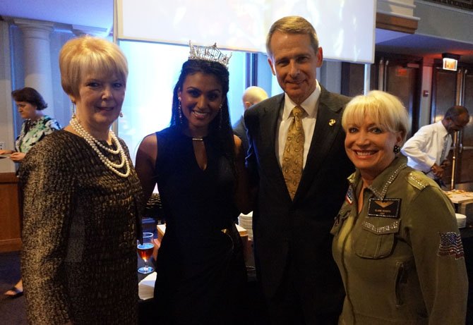 Former Chairman of the Joint Chiefs of Staff Gen. Peter Pace (ret., second from right) is joined by his wife Lynne Pace, left, Miss America Nina Davuluri, and USO-Metro president and CEO Elaine Rogers at the USO Stars and Stripes Night gala Oct. 4 at the Sheraton National Hotel in Arlington.
