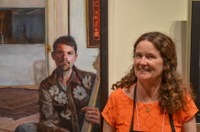 Dale McGrath standing next to Mark Giaimo's painting "The Fan."