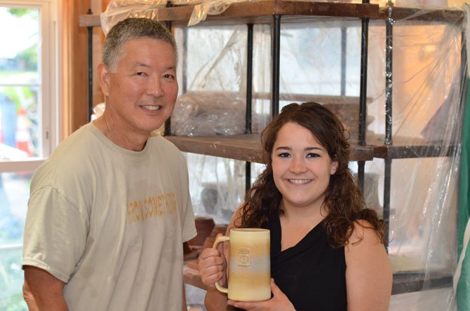 Steven Shiraishi and Olivia DiBenigno inside the Potter's Fire studio. 