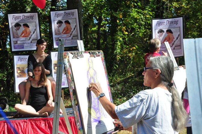 Joan Ferrum tries her hand at painting two models during the annual MPAartfest Sunday, Oct. 6. 