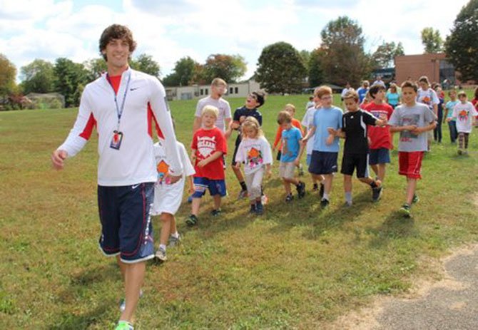 Churchill Road Physical Education teacher Jason Mastaler leads a group of students and family members on the 8th annual Help the Homeless Mini Walk for the benefit of Pathway Homes, in Northern Virginia.