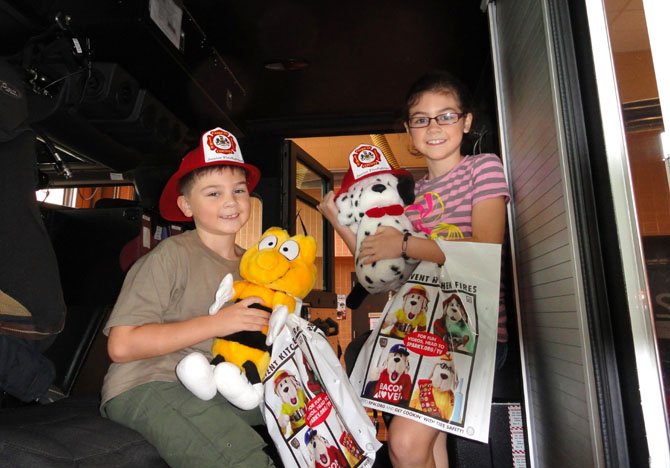 (From left) siblings Zach Topscher, 7, and sister Tessa, 8, of Greenbriar, brought their stuffed animals with them.
