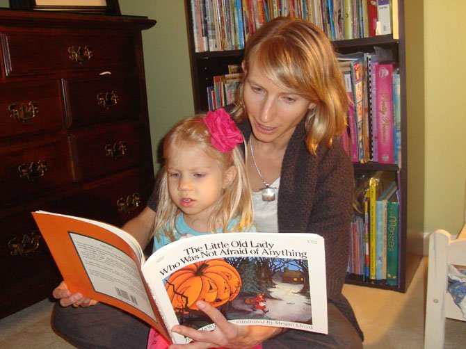 Holly Karapetkova reads the Halloween book “The Little Old Woman Who Was Not Afraid of Anything” with her daughter. “The main thing about reading with your child is giving your child your attention and having quality fun time together,” she said.