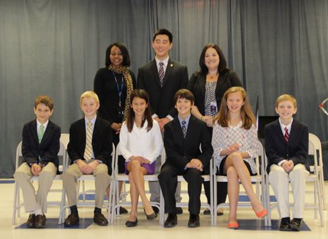 Following the induction ceremony, Churchill Road SCA officers, sponsors and the guest presenter posed for a group photo. From left (front row) are: Matthew Strong, secretary; Will Wheat, historian; Arielle Moore, sergeant-at-arms; Michael Hoeymans, treasurer; Izzy Schone, president and Sean Mullery, vice president; (back row) Churchill Road Assistant Principal Sharon Jones, Jason Cui, Langley High School SGA president; and Jamie Meyers, CRS SCA sponsor and school counselor.