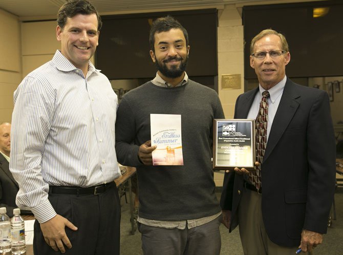 McLean Community Center (MCC) Governing Board Chair Chad Quinn, Graphic Artist Hussain Mohammed and Executive Director George Sachs hold VRPS award plaque and the winning publication.