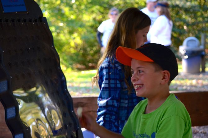 Walk participant Kevin Davis playing a game in the "Camp Oasis Kid's Zone."