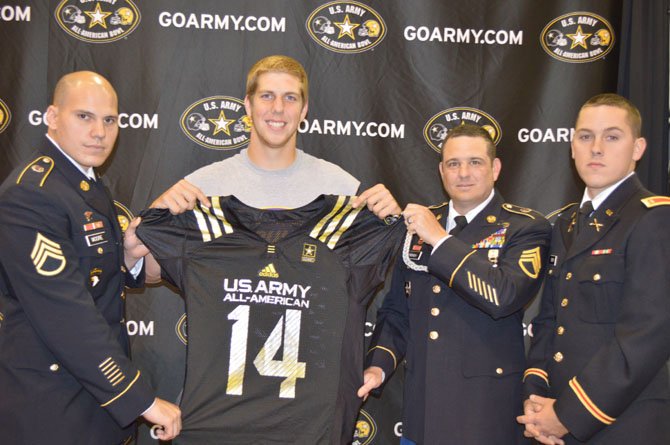 Lake Braddock quarterback Caleb Henderson received his U.S. Army All-American jersey at the school’s homecoming pep rally on Oct. 18. Pictured from left: Staff Sergeant Jacob Moore, Henderson, Staff Sergeant Randy French and Second Platoon Kevin Smith.