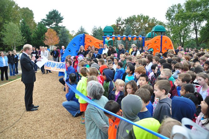 Colvin Run Elementary School Principal Kenneth Junge welcomes students to the ribbon cutting of the school’s new playground Wednesday, Oct. 23. 