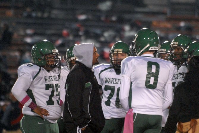 First-year Wakefield head football coach Wayne Hogwood talks to the Warriors during a game against Stuart on Oct. 25.