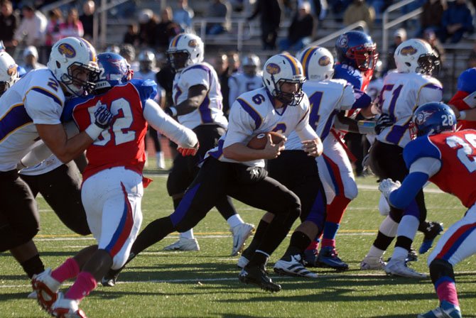 Lake Braddock quarterback Caleb Henderson got the better of T.C. Williams standout defensive players Jeremiah Clarke and Malik Carney on Oct. 25. The trio will play for the University of North Carolina next year.