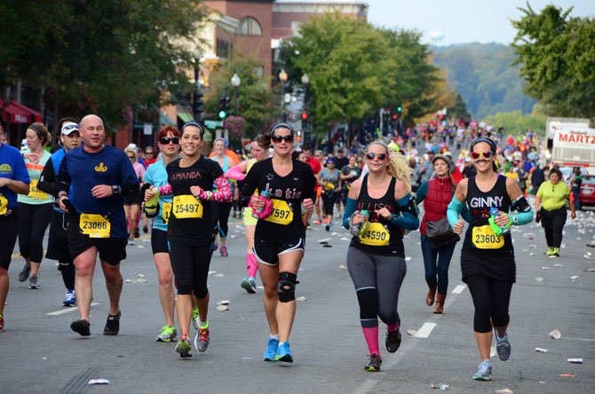 "Team Chris" jogs through Georgetown, around mile five of the 2013 Marine Corps Marathon. From left: Amanda Thoburn, Katie Ernst, Allison Byers, Ginny Atwood.