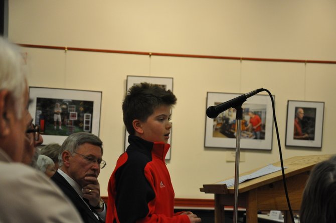 Supervisor John Foust (D-Dranesville) listens as Forestville Elementary student Grayson Miller addresses the library board committee.