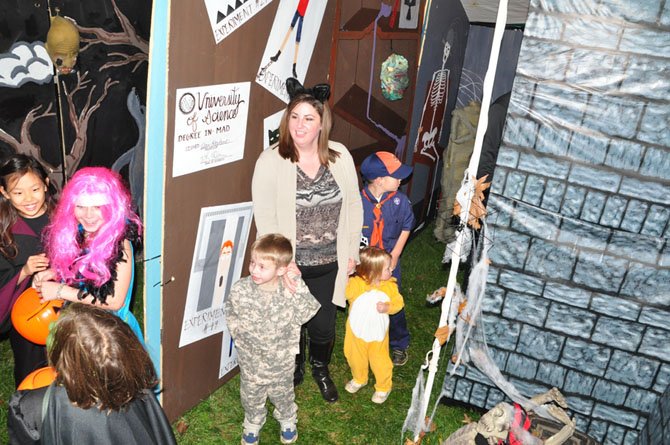 Wary visitors make their way through the Great Falls Friends and Neighbors haunted house. 