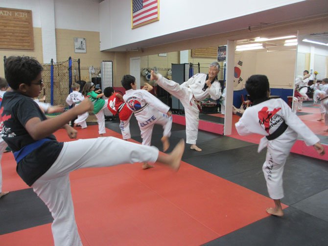 At 67 years old, Grand Master Mountain Kim can still do a high-kick. He began his own tae kwon do training 60 years ago.