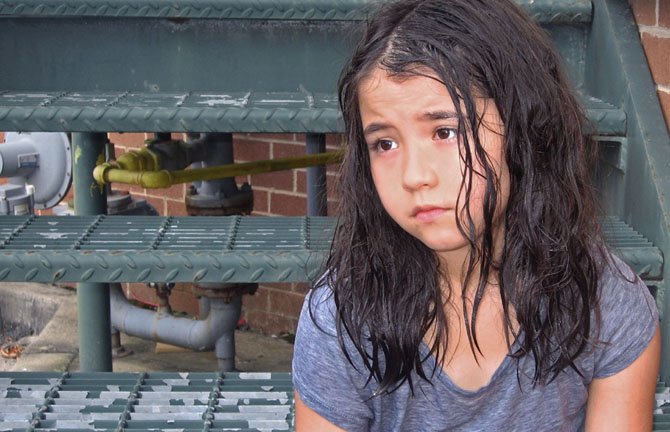 Hedy Hosford as the orphan girl from the play, "Carried Away on the Crest of a Wave," which explores the enormity of the 2004 Indian Ocean tsunami.