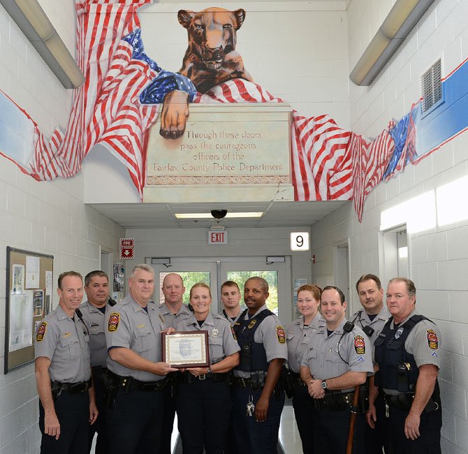 Surrounded by the Sully District Police Station’s Evening Patrol Shift, MPO Julie Hersey receives her Officer of the Month award.