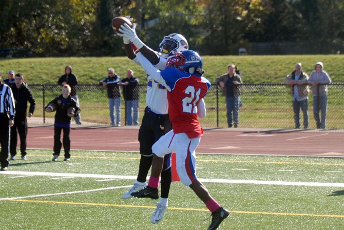 T.C. Williams' Philip Tyler (21) defends against Lake Braddock's AJ Alexander.