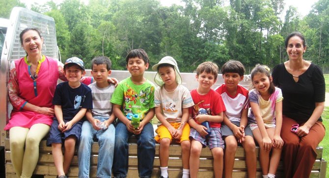 A happy crew aboard the Home Depot truck after an outdoor learning session with Home Depot community partners. Left to right: Nuria Gabitova, Aidan Stone, Collin Stella, Iyush Hoysal, Diego Tablett, Mark Chklovskii, Rohan Alemblaseril, Samantha Chklovskii and Anu Gupta.