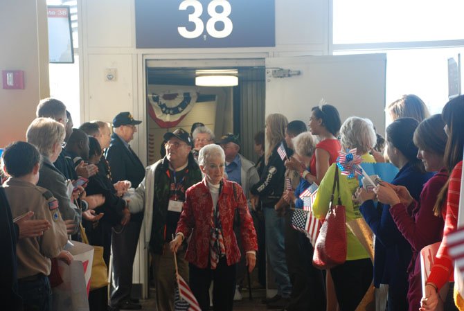 Nearly 300 people gathered at the US Airways terminal to welcome WWII veterans as part of the Honor Flight program.