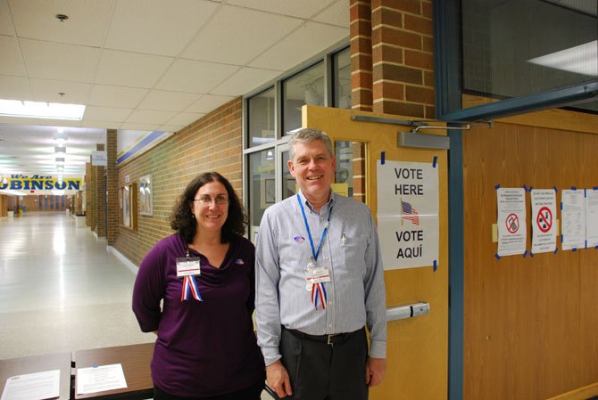 From left Robinson Secondary School Assistant Chief Election Officer Teri Ayers and Chief Election Officer James Emery Jr. welcome voters.