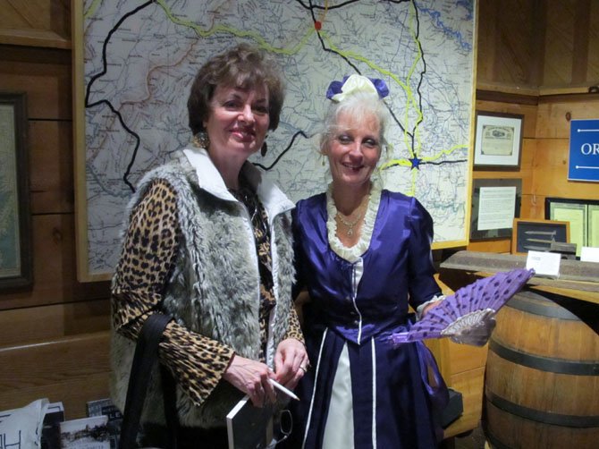 Garvey-Hodge poses with Kristi Roberts of Centreville, who spent 15 hours making the dress for the re-enactment.