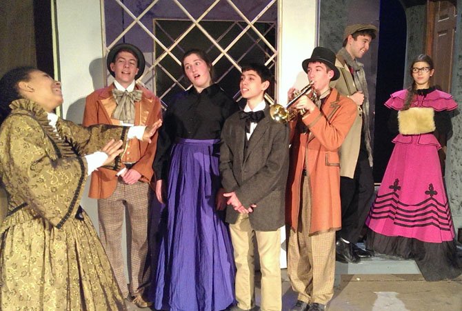 From left: Magali Palmer-Young directs carolers Bobby Kelleher, Sarah Giuseppe and Joey Arzeno, while Tommy Kelleher plays trumpet and Max Snyder and Isabella Whitfield chat.