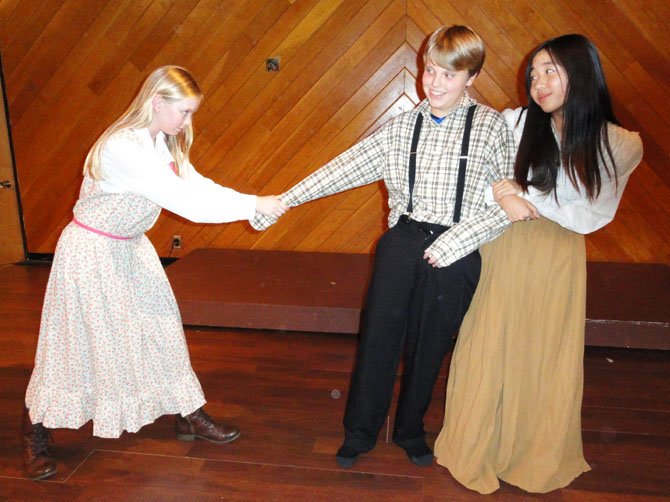 From left are Noelle Buice, Jack Wood and Jenny Lee, showing Amy Lawrence and Becky Thatcher fighting over Tom Sawyer.