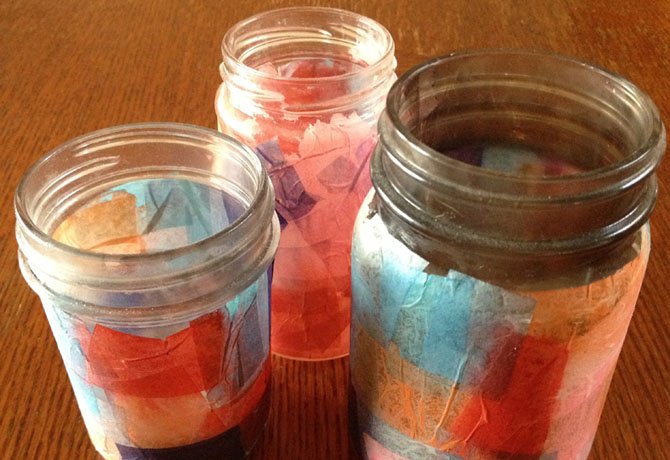 Glass jars can be recycled into candleholders with a stained glass effect.