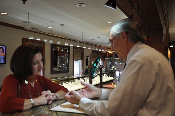 Proprietor and Master Designer, Jorge Adeler, assists Great Falls resident Mary Schroeder in the Adeler Jewelers showroom and design studio.