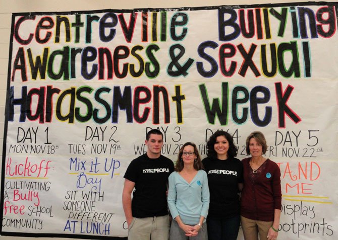 From left: Alex Jones, Lu Ann McNabb, Sophia Teie and Debbie Lawall in front of Centreville High’s anti-bullying-week banner in the cafeteria.