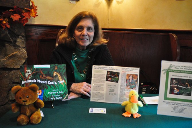 Author Pat Britz signs copies of her book at Katie’s Coffee Shop. The book, “Animals Need Zzzs Too,” addresses children’s sleep habits. 