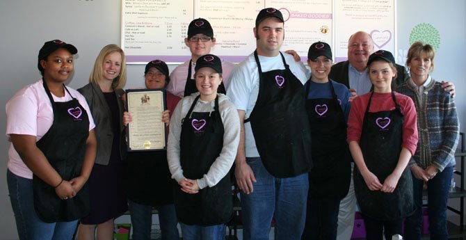 Pictured, from left: Jennifer West; Nicole Hange, the new Economic Development Director for the City of Fairfax; Maddie Leasure; Cameron Graham, after whom ‘Cameron’s Coffee and Chocolates’ was named; Rachel Dix-Kessler; Tom Jackson; Wendy Bennett; Doug Church, Central Fairfax Chamber of Commerce Founding Chairman and Director; Justina Dambrauskaite; and Ellen Graham, Founder of the Every 1 Can Work non-profit organization — and Cameron’s mom. In the photo, Maddie is holding the city’s proclamation in support of Small Business Saturday.