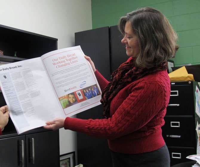 Lisa Whetzel, executive director of Our Daily Bread, holds up an advertisement of the organization that encouraged donations.  