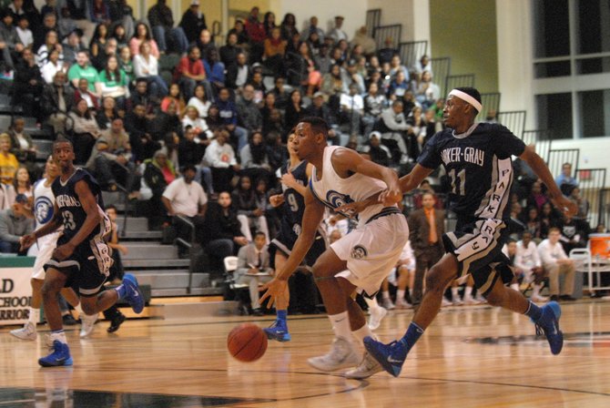 Wakefield senior Re’Quan Hopson, with ball, scored 19 points and grabbed 12 rebounds against T.C. Williams on Dec. 7.