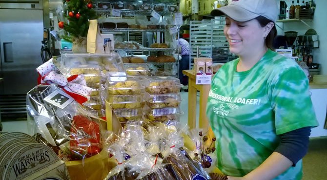 Manager Sam Gray organizes baked goods that can be included in a holiday gift package.