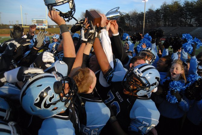The Centreville football team celebrates beating Westfield for the 6A North region championship on Dec. 7.