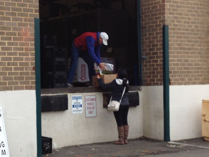 A woman picks up her monthly food donations from Food for Others in Fairfax.