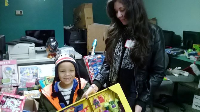 Neyda Lugunes-Loza, 13, helped Jason, 6, pick out a gift for his brother at the FACETS Holiday Sibling Shop.  