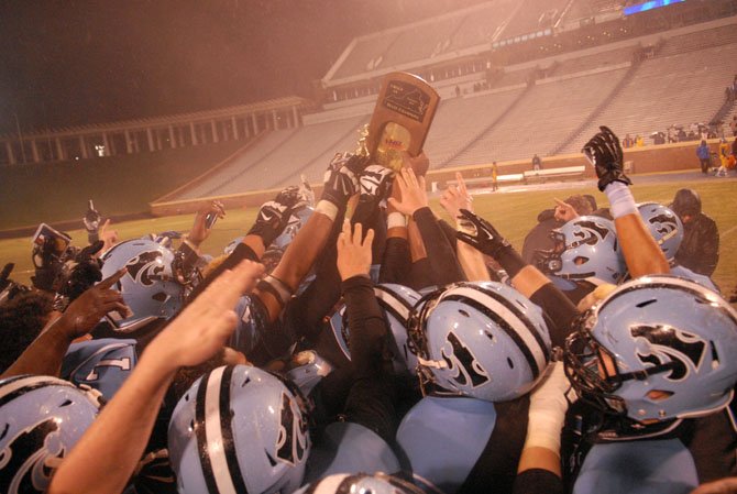 The Centreville football team celebrates after beating Oscar Smith 35-6 in the Group 6A state championship game on Dec. 14 at UVa’s Scott Stadium.