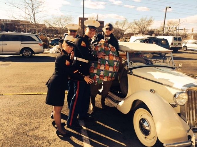 Phil Williams and three Marines unloading toys from Williams’s 1959 MG at the Juke Box Diner.