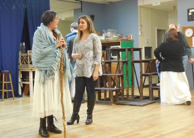 An old woman (Susanna Todd) offers to buy Fantine's (Jennifer Lambert) necklace in Reston Community Players’ rehearsal of ‘Les Miserables.’