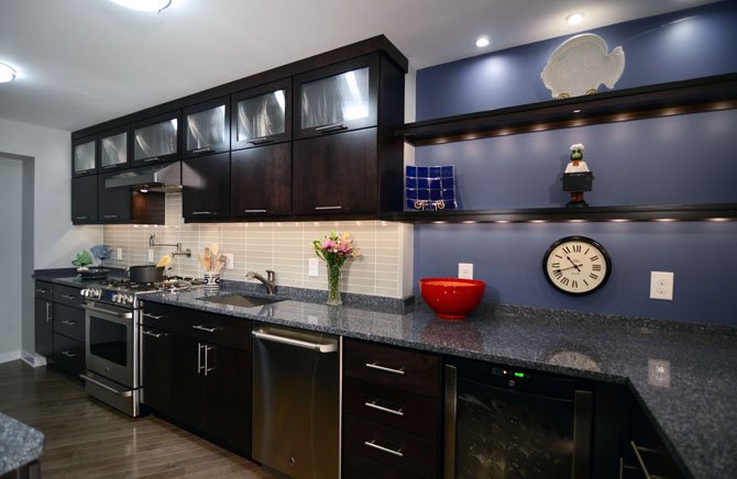 This kitchen by Case Design/Remodeling, Inc. was built with open shelving that offers extra storage as well as easy access to dinnerware. 