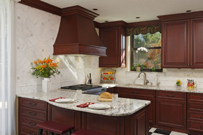 The kitchen of an Arlington condominium that includes a custom-designed range hood is among the top 2013 spaces by BOWA Builders, Inc.