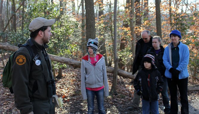 Kevin Koons, left, speaks to participants in the First Day Hike, including the Houck family of Burke.