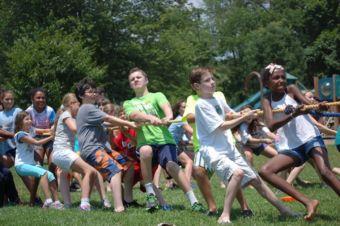 Students at the Summer at Norwood camp play tug-of-war. Experts say summer camps should offer opportunities for play, socialization and rest.