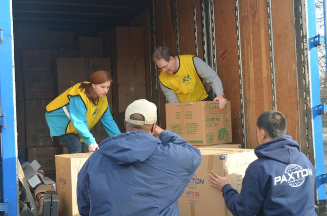 Volunteers load boxes of blankets into a truck at an LDS church in Vienna.