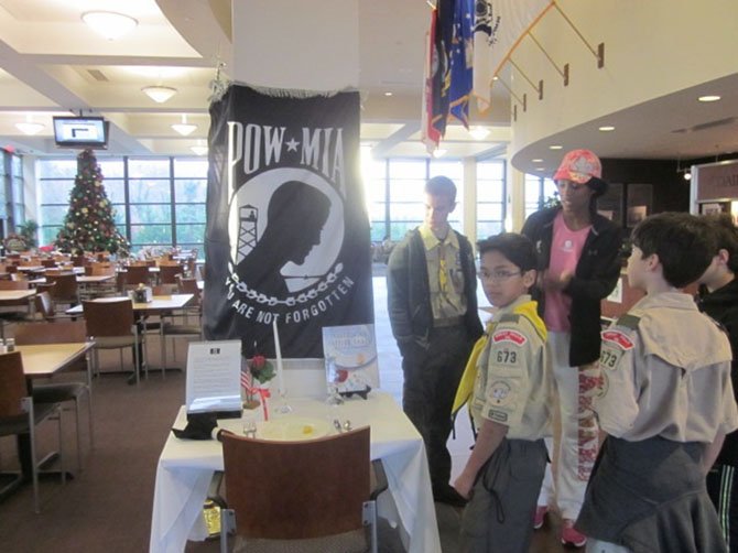Sgt. Watkins shows the Scouts the POW/MIA table.